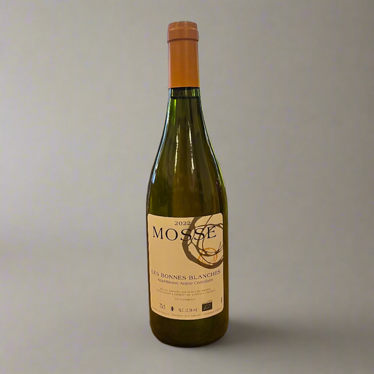 Bottle of Mosse wine on a wooden table with a store interior in the background