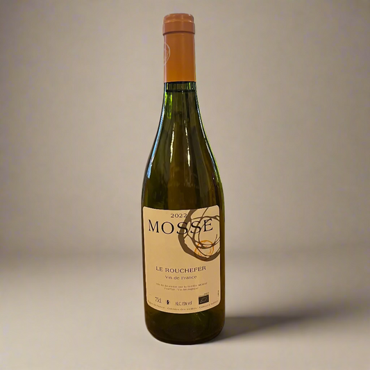 Bottle of Mosse wine on a wooden table with a store interior in the background